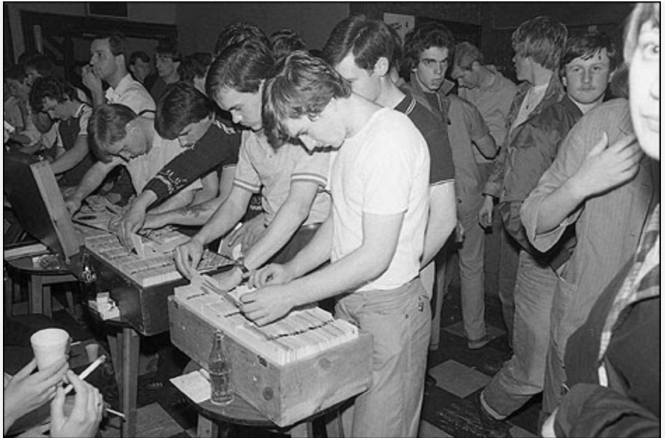 Dancers crowded around the record bar at Wigan Casino, flicking through boxes of 45s